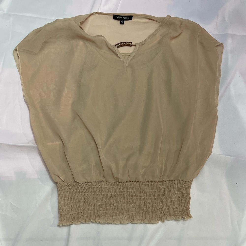 Woman’s beige blouse